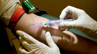 A nurse takes a blood sample