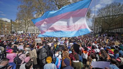 People take part in a demonstration outside Downing Street in London, to protest against the exclusion of transgender people from a ban on conversion therapy.
