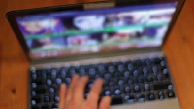 A laptop with pictures of models and cam girls.