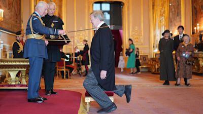 Sir Stephen Fry receives his Knighthood from King Charles III at Windsor Castle. Credit: PA