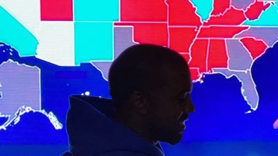 Kanye West in front of a US election map
