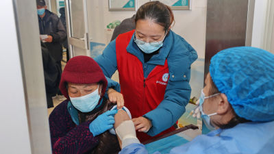 An elderly woman gets vaccinated against COVID-19 at a community health center in Nantong in eastern China's Jiangsu province on Dec. 9, 2022. The National Health Commission announced a campaign on Nov. 29 to raise the vaccination rate among older Chinese, which health experts say is crucial to avoiding a health care crisis. It's also the biggest hurdle before the ruling Communist Party can lift the last of the world’s most stringent antivirus restrictions. (Chinatopix Via AP)