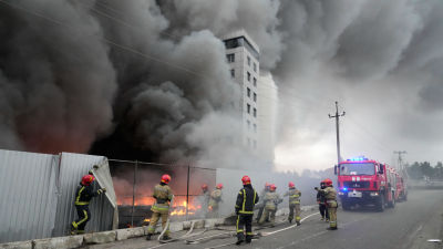Firefighters work to extinguish a fire at a damaged logistic center after shelling in Kyiv