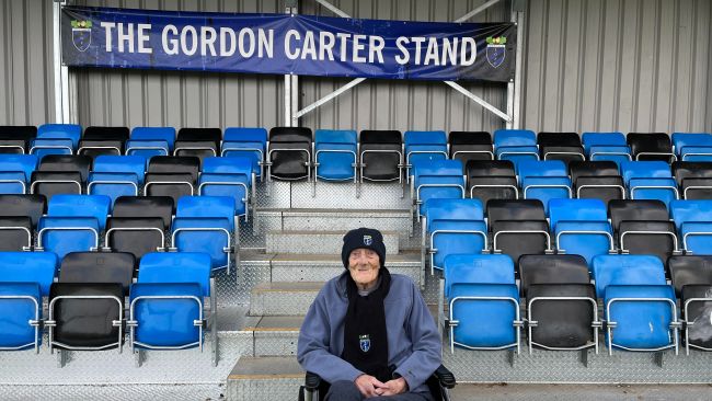 Gordon Carter poses for a picture in front of the stand that's been named after him.