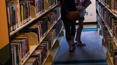 Borrowers check out books at a library