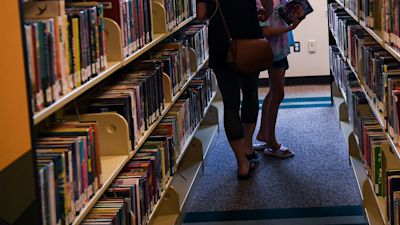 Borrowers check out books at a library
