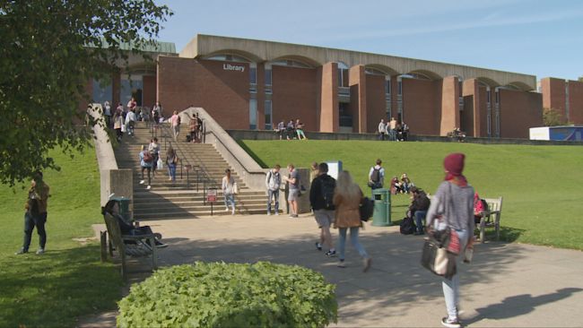 An image of people walking around the University of Sussex.