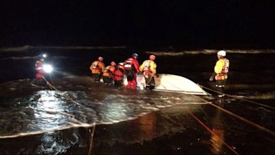 Shots of the upturned boat in which three men died