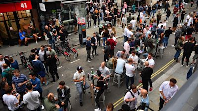 People drinking on the streets of Soho, London.