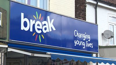 A sign above a break charity shop