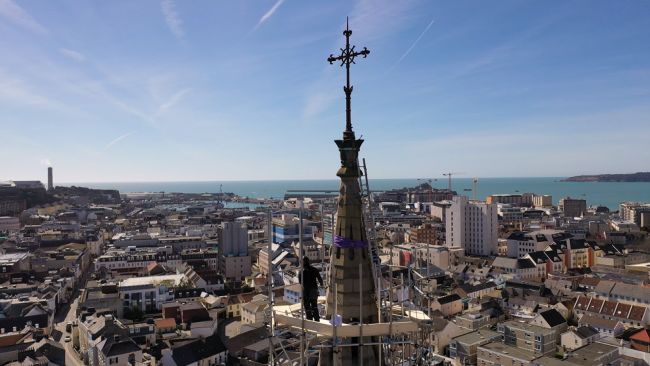 Drone shot of St Thomas' Church Spire with view of St Helier out to sea.