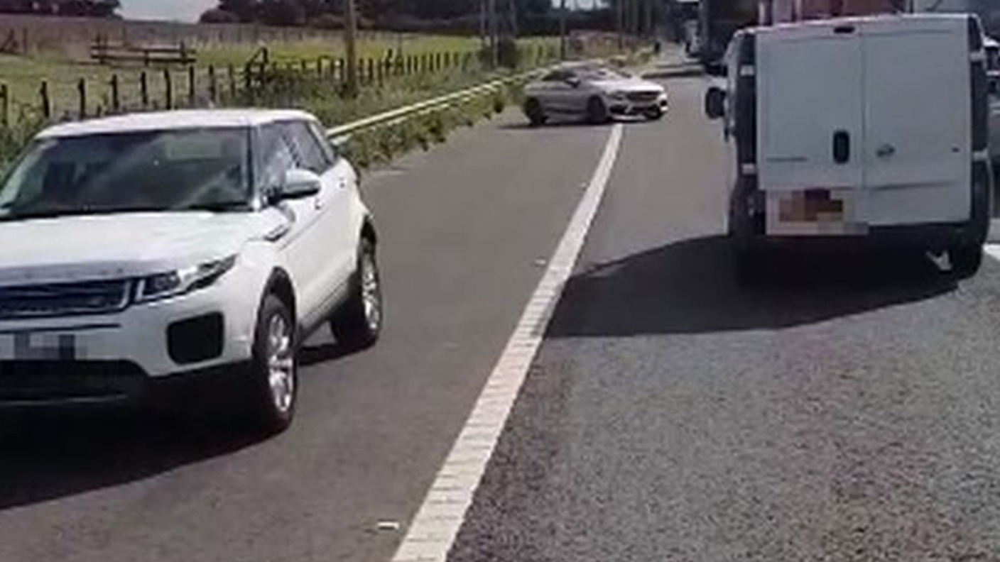 Driver filmed going wrong way down motorway hard shoulder after crash ...