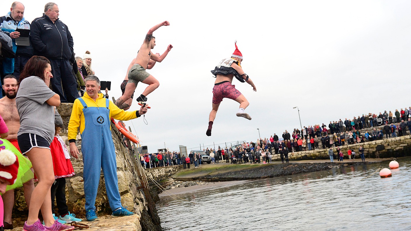 New Year swimmers brave chilly waters for charity dip | UTV | ITV News