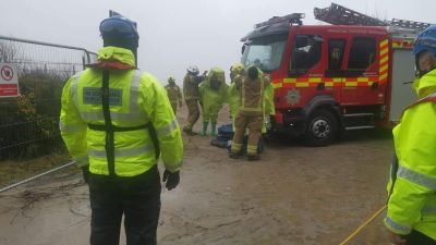 Firefighters in hazmat suits on Cornwall beach