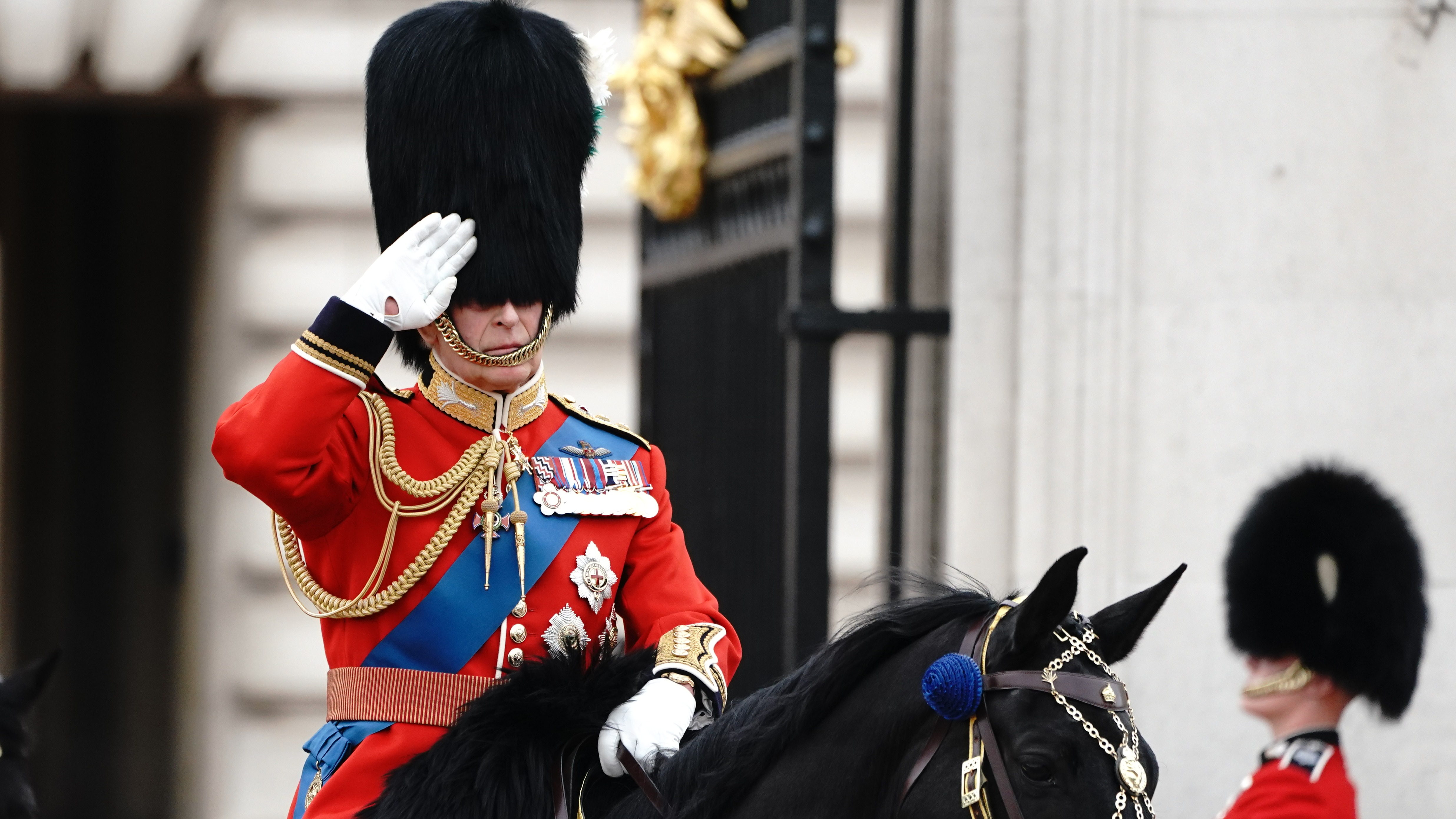 Charles presents flag to mounted cavalry ahead of first birthday parade