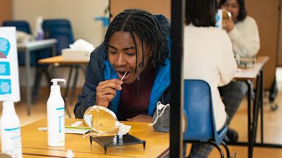 A student takes a Lateral Flow Test for coronavirus at Oasis Academy Shirley Park in Croydon, south London, as pupils in England return to school for the first time in two months as part of the first stage of lockdown easing. Picture date: Monday March 8, 2021. Aaron Chown/PA