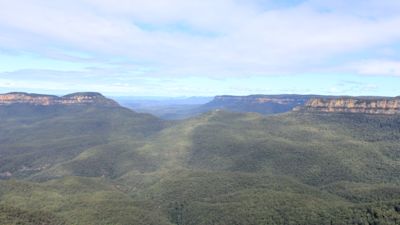 A 49-year-old man and his nine-year-old son have died after being caught up in a landslide while holidaying in Australia.