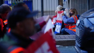 Protesters from Insulate Britain blocking a road near Canary Wharf in east London. Climate group Insulate Britain had pledged to restart its road-blocking protests despite the risk of its members being jailed or fined. Picture date: Monday October 25, 2021.
