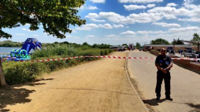 A teenage boy is "unaccounted for" after entering a lake in an East London country park in the early hours of the morning. 
A police search has been launched after the 17-year-old was seen entering Fairlop Waters in Ilford at around 12.30am this morning (Monday, July 4).
The boy's next of kin have been informed while a search is carried out in the water. Officers from the Metropolitan Police attended along with the London Ambulance Service and London Fire Brigade, while a police helicopter was also called to the scene.
Pictures show tape around the entrance to the lake with dog units, two police vans, a police car and park patrol car stationed inside. The lake also has an inflatable assault course.
It is understood that divers are set to enter the lake to assist with the search. 
A local parliamentary candidate, Kam Rai, said it appears to be an incident of "misadventure" on the lake.
Redbridge Council said in a statement: “Following an incident on the lake at Fairlop Waters in the early hours of this morning, the park is closed to visitors at the request of the emergency services.
"At this moment we do not know when the park will be re-opened. Please check our website for further updates.”
The Met Police said: "Police were called to Fairlop Waters, Ilford, shortly after 12:30am on Monday, July 4, to reports of a concern for safety.
"Officers attended along with London Ambulance Service and London Fire Brigade. It was reported that a 17-year-old boy had entered the water and was unaccounted for.
"The National Police Air Service (NPAS) was called to the scene to help with the search.
"The boy's next of kin have been informed."