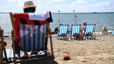 Visitors enjoy the sunny weather on the beach at Southend in Essex.