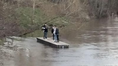 The teenagers were stranded on a loose jetty before being rescued by a passerby