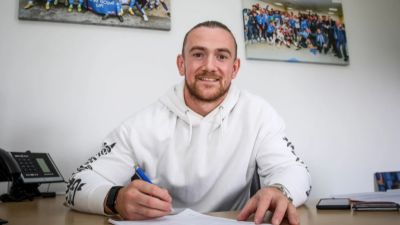 Jack Marriott signs his contract with Peterborough United.