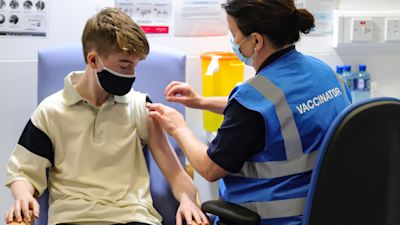 Kevin Mckeon, 14, receives his first dose of the Covid-19 vaccine from vaccinator Geraldine Flynn at the Citywest vaccination centre in Dublin. Vaccinations of children and teenagers is underway across Ireland, with more than 23 percent of those aged 12 to 15 registered to receive the jab. Picture date: Saturday August 14, 2021. Damien Storan/PA