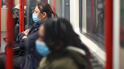 Tube passengers with face masks