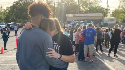 Two teens embrace at a prayer vigil on Sunday, April 16, 2023, outside First Baptist Church in Dadeville, Ala. Several people were killed and over two dozen were injured in a shooting at a teen birthday party in the town on Saturday, April 15.