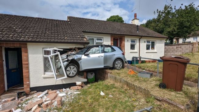 This is the moment a car crashed into a bungalow, with the vehicle hanging off the property.