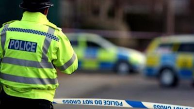 Stock shot of police officer and cars.
Credit: PA