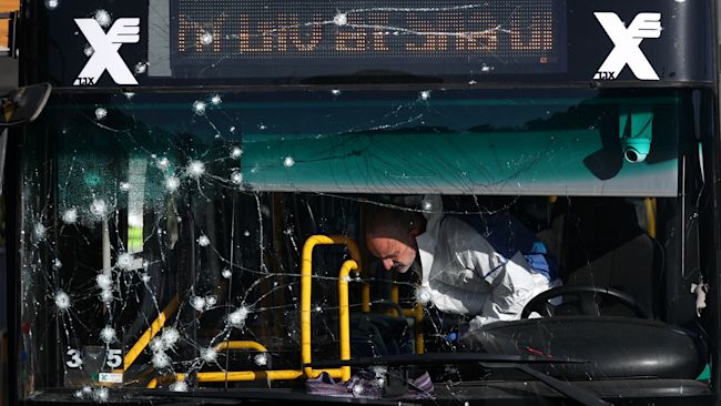 Israeli police inspect the scene of an explosion at a bus stop in Jerusalem, Wednesday, Nov. 23, 2022. Two blasts went off near bus stops in Jerusalem on Wednesday, injuring several people in what police said were suspected attacks by Palestinians. (Ohad Zwigenberg/HAARETZ via AP)