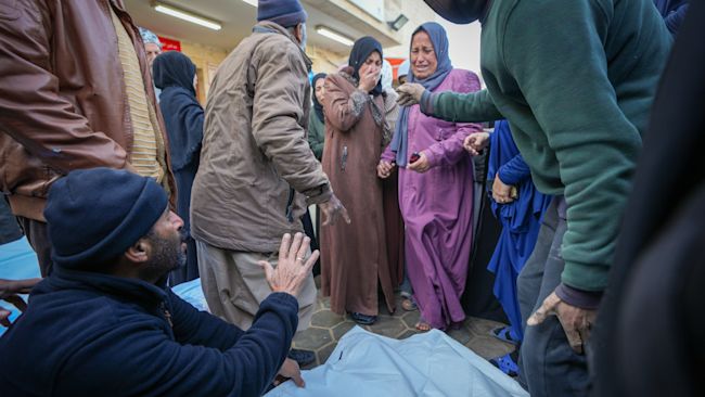 Relatives mourn as the bodies of victims from overnight Israeli army strikes at multiple locations in the central Gaza Strip AP