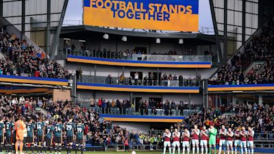 Players from Burnley and Chelsea stand for a moment of reflection and solidarity with Ukraine