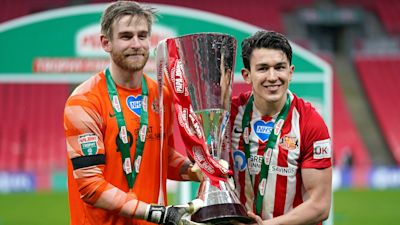 Sunderland goalkeeper Lee Burge (left) and Luke O'Nien celebrates with the Papa John's Trophy after the 2021 final at Wembley Stadium, London. Picture date: Sunday, March 14, 2021.