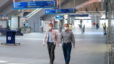Passengers wearing protective face masks at London Bridge station in London