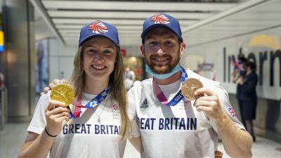 Charlotte Worthington who won gold in the BMX Freestyle and Declan Brooks who won bronze arrive back at London Heathrow Airport from the Tokyo 2020 Olympic Games.