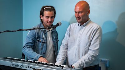 Richard Stevens, 54, with his 16-year-old son Oscar at home in Borehamwood, Hertfordshire. Mr Stevens applied for more than 200 jobs after being made redundant last year, and finally secured a new job after sending an interviewer a copy of a song called 'Paper Me' that he had recorded with Oscar about being judged on his CV.