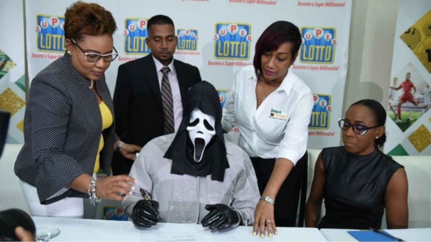 Lottery winner wears Scream mask to collect multi-million prize | ITV News