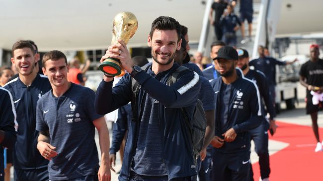 Hugo Lloris all smiles as he holds another team's shirt and