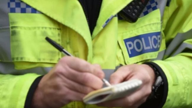 Police officer writing notes. Stock image. 