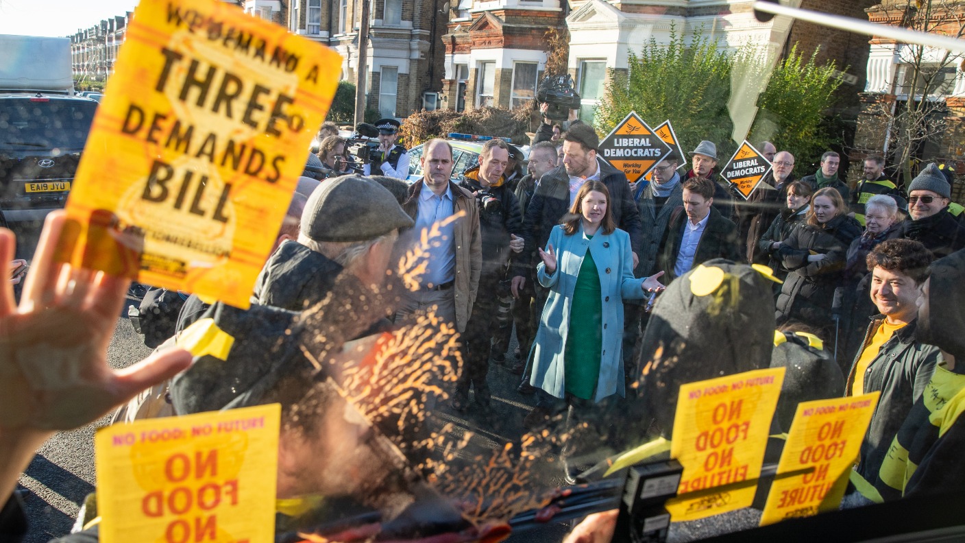 Extinction Rebellion protester dressed as bumble bee glues themself to ...