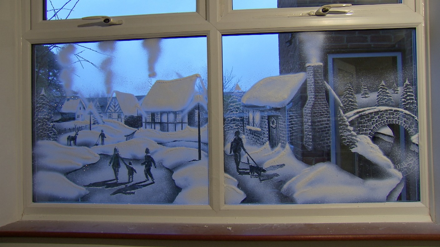 World's first snow-spray artist creates stunning winter windows