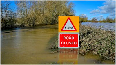 A road closed sign pokes out above floodwater and alerts motorists of flooding on the B4213 between Lower Apperlay and Tirley in Gloucestershire, which has become impassable after the River Severn has flooded the surrounding areas. PA Photo. Picture date: Monday March 2, 2020.