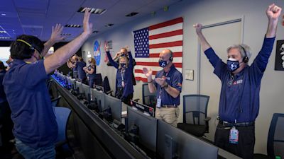 NASA's Perseverance rover team react in mission control after receiving confirmation the spacecraft successfully touched down on Mars.