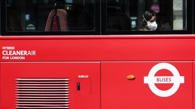 A person wearing a face mask rides a bus on Piccadilly, London, following the introduction of measures to bring England out of lockdown.
