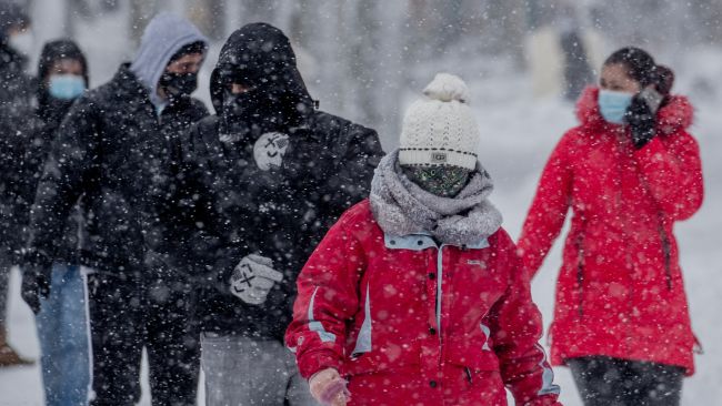 People walk during a heavy snowfall in Rivas Vaciamadrid, Spain.