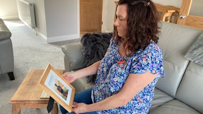 Emma Frame looks at photo of her father