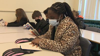 A student at Notre Dame High School in Norwich wears a mask - and coat - in class.
