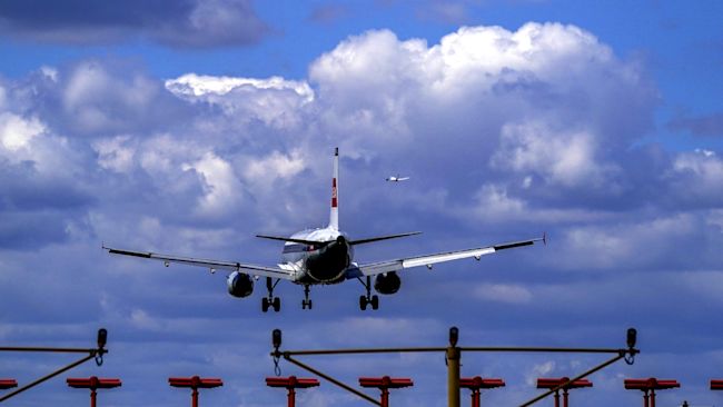 A plane lands on the southern runway at London Heathrow Airport. US and EU travellers who are fully vaccinated against coronavirus will be allowed to enter England and Scotland without the need to quarantine from Monday. Travellers will be required to take a pre-departure test, and a PCR test on or before the second day after their arrival. Picture date: Thursday July 29, 2021.